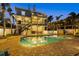 Backyard pool with brick pavers and a two-story home with dual covered patios at 2438 Baywood W Dr, Dunedin, FL 34698