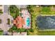 Aerial view showcasing the community pool, clubhouse, and a pond with a fountain amidst lush landscaping at 2745 62Nd E Ave, Ellenton, FL 34222