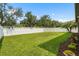 Expansive backyard featuring a well-maintained lawn, privacy fence, and manicured landscaping at 2745 62Nd E Ave, Ellenton, FL 34222