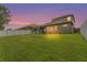 Spacious backyard with lush green grass and a white fence, perfect for outdoor activities and privacy at 2745 62Nd E Ave, Ellenton, FL 34222