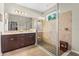 Modern bathroom featuring a glass-enclosed shower, double vanity, and tiled walls at 2745 62Nd E Ave, Ellenton, FL 34222