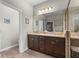 Bathroom vanity featuring a dark brown cabinets and granite countertops with modern lighting fixtures above the mirror at 2745 62Nd E Ave, Ellenton, FL 34222