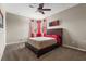 Bedroom with a dark wood bedframe and two windows at 2745 62Nd E Ave, Ellenton, FL 34222