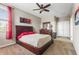Comfortable bedroom boasts a ceiling fan, dresser, and double-door closet with light-colored walls and carpet at 2745 62Nd E Ave, Ellenton, FL 34222