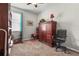 Bedroom with cherry wood furniture and exercise equipment with beige carpet, a ceiling fan, and a window at 2745 62Nd E Ave, Ellenton, FL 34222