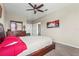 Relaxing bedroom showcasing a plush bed, dresser, and decor with a ceiling fan and neutral paint at 2745 62Nd E Ave, Ellenton, FL 34222