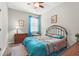 Bedroom featuring a metal bed frame, blue curtains, beige carpet and matching bedside tables and lamps at 2745 62Nd E Ave, Ellenton, FL 34222