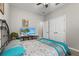 Cozy bedroom featuring a TV, walk-in closet, neutral walls, and a comfortable bed with patterned bedding at 2745 62Nd E Ave, Ellenton, FL 34222