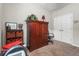 Bedroom featuring a cherry wood wardrobe and a ceiling fan, with beige carpet and a window at 2745 62Nd E Ave, Ellenton, FL 34222