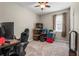Neutral bedroom featuring a ceiling fan, window with curtains, and personal items at 2745 62Nd E Ave, Ellenton, FL 34222