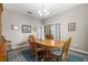 Classic dining room features an oval wooden table, chairs and a patterned rug under a traditional chandelier at 2745 62Nd E Ave, Ellenton, FL 34222