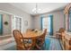 Dining room with wooden table, chairs, a blue rug, and a window with blue curtains near french doors at 2745 62Nd E Ave, Ellenton, FL 34222