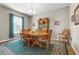 Traditional dining room with wooden table, chairs, china cabinet, and a blue patterned rug under a chandelier at 2745 62Nd E Ave, Ellenton, FL 34222