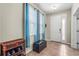 Welcoming entryway with tile floors, a storage bench, a window with curtains, and a white front door at 2745 62Nd E Ave, Ellenton, FL 34222