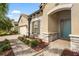Home exterior showing stone detail, an arched entry, and a paver walkway with manicured landscaping at 2745 62Nd E Ave, Ellenton, FL 34222