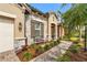 Close-up of a home's exterior featuring stone accents, decorative shutters, and a landscaped walkway at 2745 62Nd E Ave, Ellenton, FL 34222