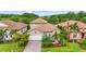 Charming single-Gathering home with a well-manicured lawn, paver driveway, tile roof, and tropical landscaping at 2745 62Nd E Ave, Ellenton, FL 34222