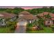 Charming single-Gathering home with a well-manicured lawn, paver driveway, tile roof, and tropical landscaping at 2745 62Nd E Ave, Ellenton, FL 34222