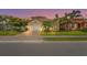 Charming single-story home boasts lush landscaping, a paver driveway, and a two-car garage, set against a beautiful twilight sky at 2745 62Nd E Ave, Ellenton, FL 34222
