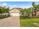 Well-maintained single-Gathering home with a two-car garage, paver driveway, and lush lawn at 2745 62Nd E Ave, Ellenton, FL 34222