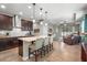 Modern kitchen with an island, pendant lighting, dark wood cabinets, and stainless steel appliances at 2745 62Nd E Ave, Ellenton, FL 34222