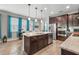 Open concept kitchen with an island, stainless steel appliances, granite countertops, and wood cabinetry at 2745 62Nd E Ave, Ellenton, FL 34222