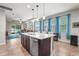 Open kitchen with a large island, stainless steel appliances, and views into the living area at 2745 62Nd E Ave, Ellenton, FL 34222