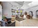 Open lounge area with tile flooring, comfortable couches, tables, and arched windows providing ample natural light at 2745 62Nd E Ave, Ellenton, FL 34222