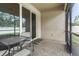Covered screened patio features a glass table and chairs on a brick paver surface with a screen door at 2745 62Nd E Ave, Ellenton, FL 34222