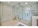 The modern bathroom offers a large glass shower, an adjacent toilet, and sleek, neutral toned tile throughout at 301 Quay Commons Dr # 1711, Sarasota, FL 34236