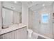 Sleek bathroom features glass shower and vanity with clean, modern lines and beach view at 301 Quay Commons Dr # 1711, Sarasota, FL 34236