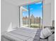 Bright bedroom with expansive windows providing beautiful water views and access to a balcony at 301 Quay Commons Dr # 1711, Sarasota, FL 34236