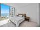 Bright bedroom features a large window with water views and minimal contemporary decor at 301 Quay Commons Dr # 1711, Sarasota, FL 34236