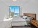 This bright bedroom has ample natural light, neutral tones, and beautiful water views at 301 Quay Commons Dr # 1711, Sarasota, FL 34236