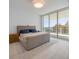 The bedroom features tile flooring, a large window with city views, and a comfy bed at 301 Quay Commons Dr # 1711, Sarasota, FL 34236