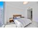 Bright bedroom features a large window with water views and minimal contemporary decor at 301 Quay Commons Dr # 1711, Sarasota, FL 34236