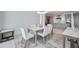 Dining area with a modern table and chairs, offering a view of the adjacent living and kitchen areas at 301 Quay Commons Dr # 1711, Sarasota, FL 34236
