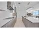 Well-designed kitchen featuring gray cabinets, a central island with a sink, and state-of-the-art appliances at 301 Quay Commons Dr # 1711, Sarasota, FL 34236