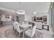 Open-concept living and dining area featuring modern lighting, a dining table, and a comfortable seating area at 301 Quay Commons Dr # 1711, Sarasota, FL 34236