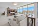Bright living room featuring built-in shelving, modern decor, and expansive windows showcasing scenic views at 301 Quay Commons Dr # 1711, Sarasota, FL 34236