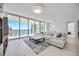 Bright living room featuring floor-to-ceiling windows, a large sectional sofa, and elegant decor and furniture at 301 Quay Commons Dr # 1711, Sarasota, FL 34236