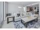 Cozy living area showcases a marble-topped coffee table and plush sofa on a stylish patterned rug at 301 Quay Commons Dr # 1711, Sarasota, FL 34236