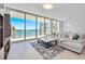 Modern living room with a comfortable seating area and gorgeous water views at 301 Quay Commons Dr # 1711, Sarasota, FL 34236