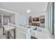 Open living space with stylish furnishings, entertainment center, and expansive windows for plenty of natural light and water views at 301 Quay Commons Dr # 1711, Sarasota, FL 34236