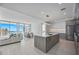 Bright, open living space featuring a modern kitchen, dining area, and cozy living room with expansive windows at 301 Quay Commons Dr # 1711, Sarasota, FL 34236