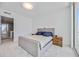 Minimalist main bedroom offers a serene space with a comfortable bed, modern nightstands, and ample natural light at 301 Quay Commons Dr # 1711, Sarasota, FL 34236