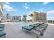 Luxury condo building pool deck with many lounge chairs overlooking the city at 301 Quay Commons Dr # 1711, Sarasota, FL 34236