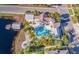 Aerial view of the home showcasing a uniquely-shaped private pool, a dock, and waterfront access at 311 Compass Point Dr # 101, Bradenton, FL 34209