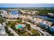 An aerial view of a neighborhood, highlighting a community pool, lush landscaping, and tranquil waterways at 311 Compass Point Dr # 101, Bradenton, FL 34209
