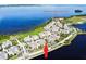 Aerial view of luxury community with waterfront homes, clubhouse, pool, spa, restaurant, and gym at 311 Compass Point Dr # 101, Bradenton, FL 34209